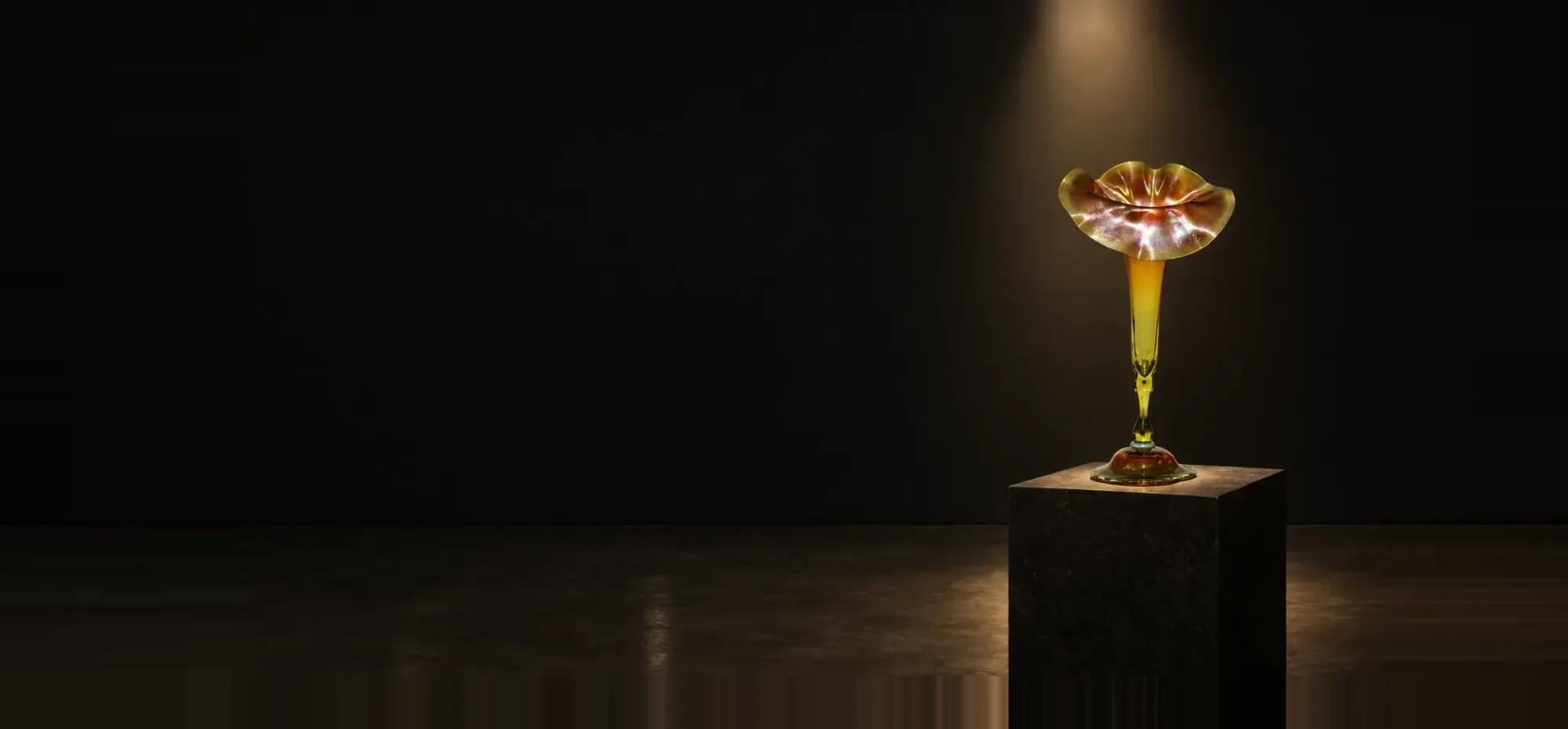 Iridescent art glass jack-in-the-pulpit vase glowing under a spotlight in a dark gallery
